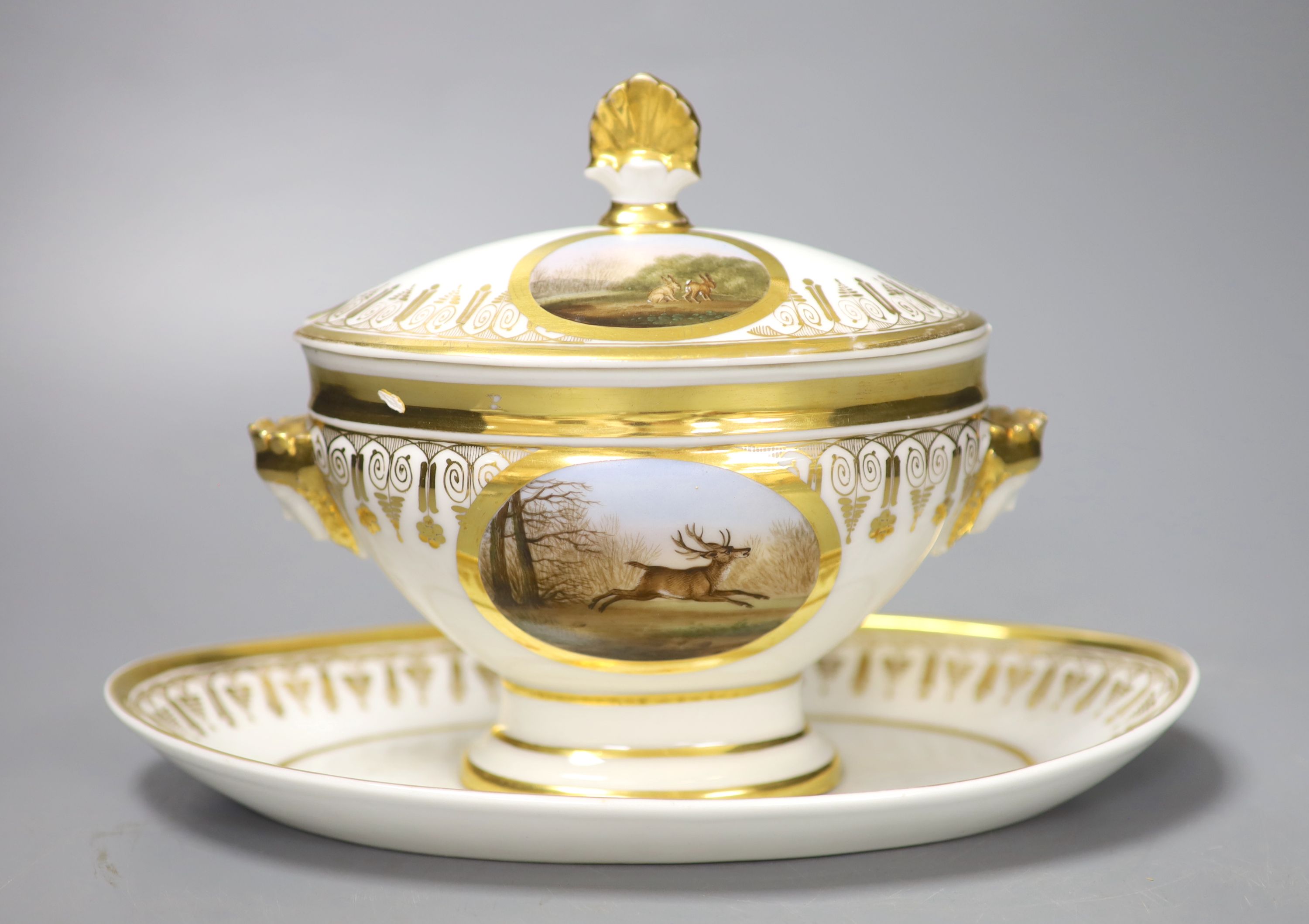 A Paris porcelain tureen and cover highly gilded and painted with four oval panels, two with dogs, one with a stag and one with two har